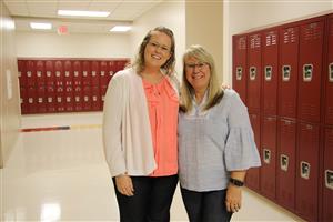 Two teachers standing next to each other in a picture 